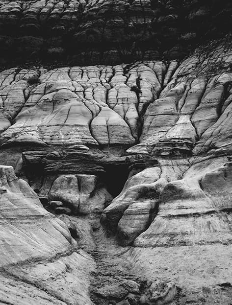 Black and white image of a rock formation with striations forming an intricate pattern in Wyoming, USA